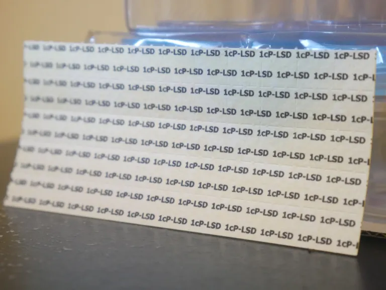 1P-LSD blotter tab close-up with lab-sealed packaging – premium quality UK research chemical
